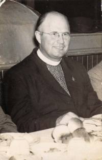 Photograph of Father Zarsky wearing an embroidered shirt.